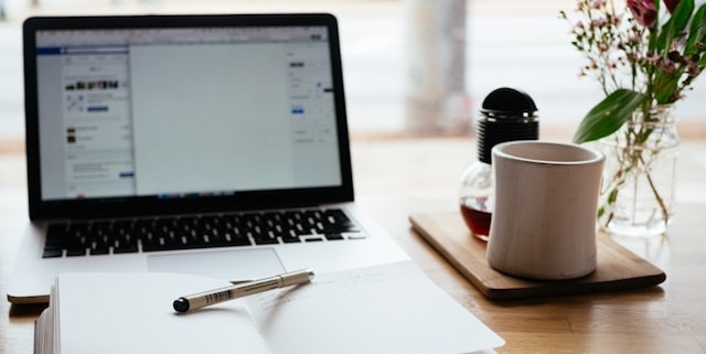 Open journal and laptop on table.
